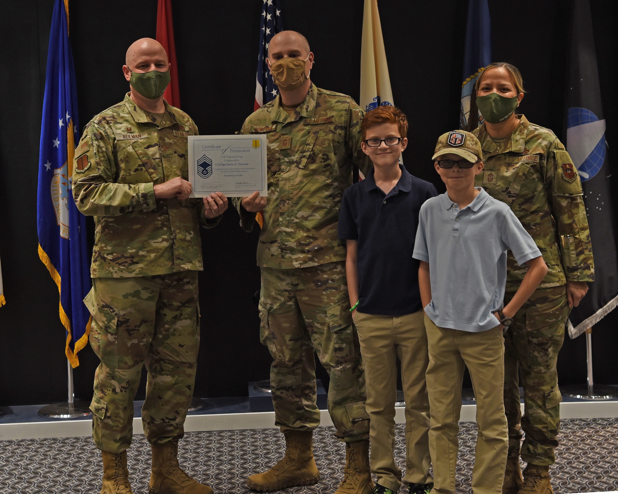 U.S. Air Force Col. Matthew Reilman, 17th Training Wing commander, awards Chief Master Sgt. select Darrin Donovan, 17th Security Forces Squadron operations superintendent, a promotion certificate at the Chief Master Sgt. Release Ceremony at the Powell Event Center on Goodfellow Air Force Base, Texas, Dec. 9, 2021. At 1 percent of the force, only 544 Airmen and Guardians were selected for senior and chief master sergeant in their respective promotion cycles. (U.S. Air Force photo by Senior Airman Abbey Rieves)