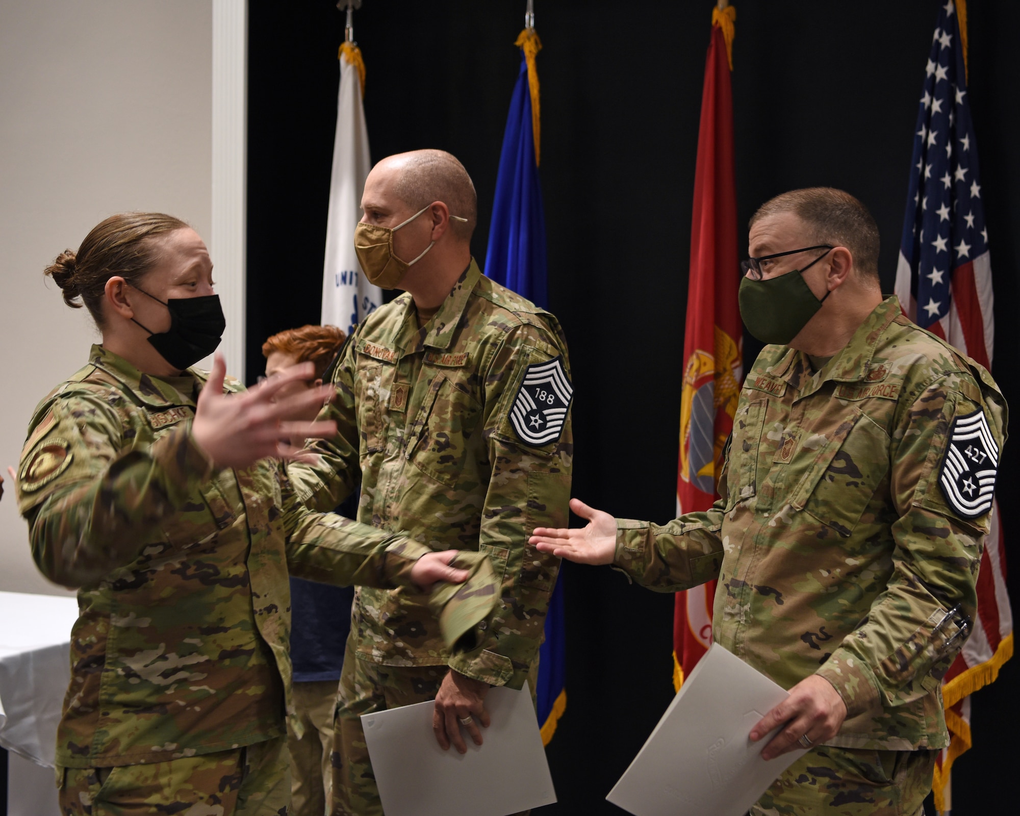 U.S. Air Force Master Sgt. Staci Kasischke, 17th Force Support Squadron career assistance advisor, congratulates Chief Master Sgt. select David Weaver, 17th Comptroller Squadron senior enlisted leader, on his promotion at the Chief Master Sgt. Release Ceremony in the Powell Event Center on Goodfellow Air Force Base, Texas, Dec. 9, 2021. Less than 1 percent of enlisted personnel are selected to become chief master sergeants. (U.S. Air Force photo by Senior Airman Abbey Rieves)