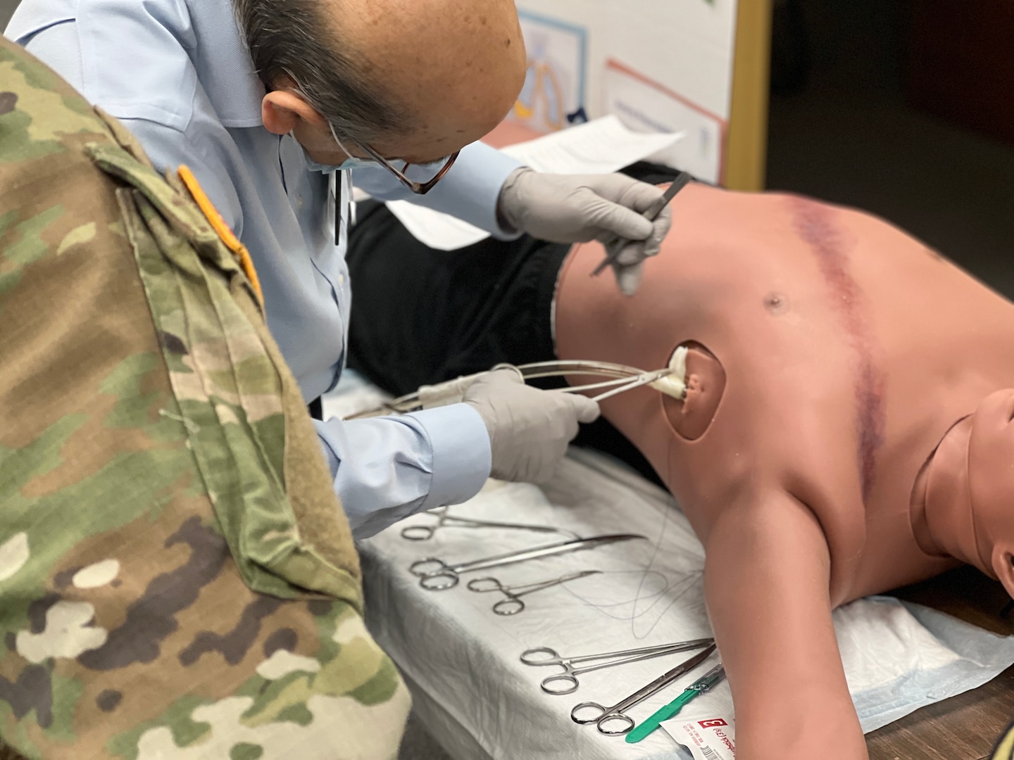 Dr. M. Farrukh Ali Khan, general surgeon, Bayne-Jones Army Community Hospital demonstrates proper placement of a chest tube during the area of concentration, individual critical task list skills fair Dec. 13 at the Joint Readiness Training Center and Fort Polk, Louisiana.