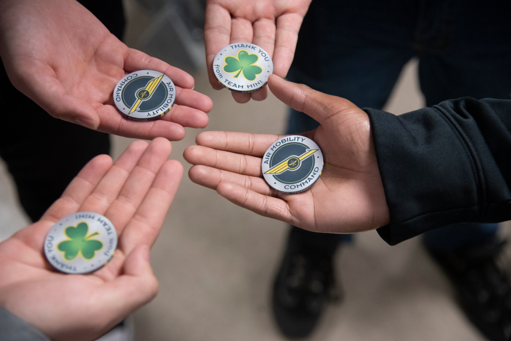 Students from the Hillsborough County School District (HCSD) hold out coins presented by U.S. Air Force Gen. Mike Minihan, commander of Air Mobility Command, Dec. 9, 2021, at MacDill Air Force Base, Florida.