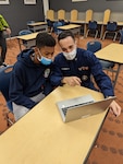 A recruiter uses a 2-in-1 device with a prospective recruit.