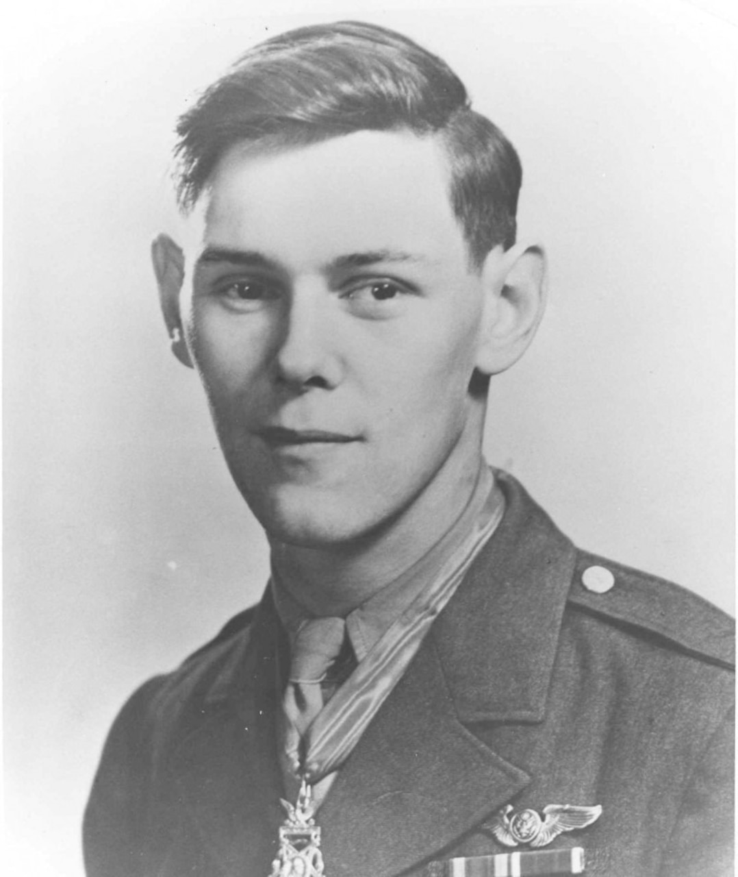 A man in service uniform poses for a photo.