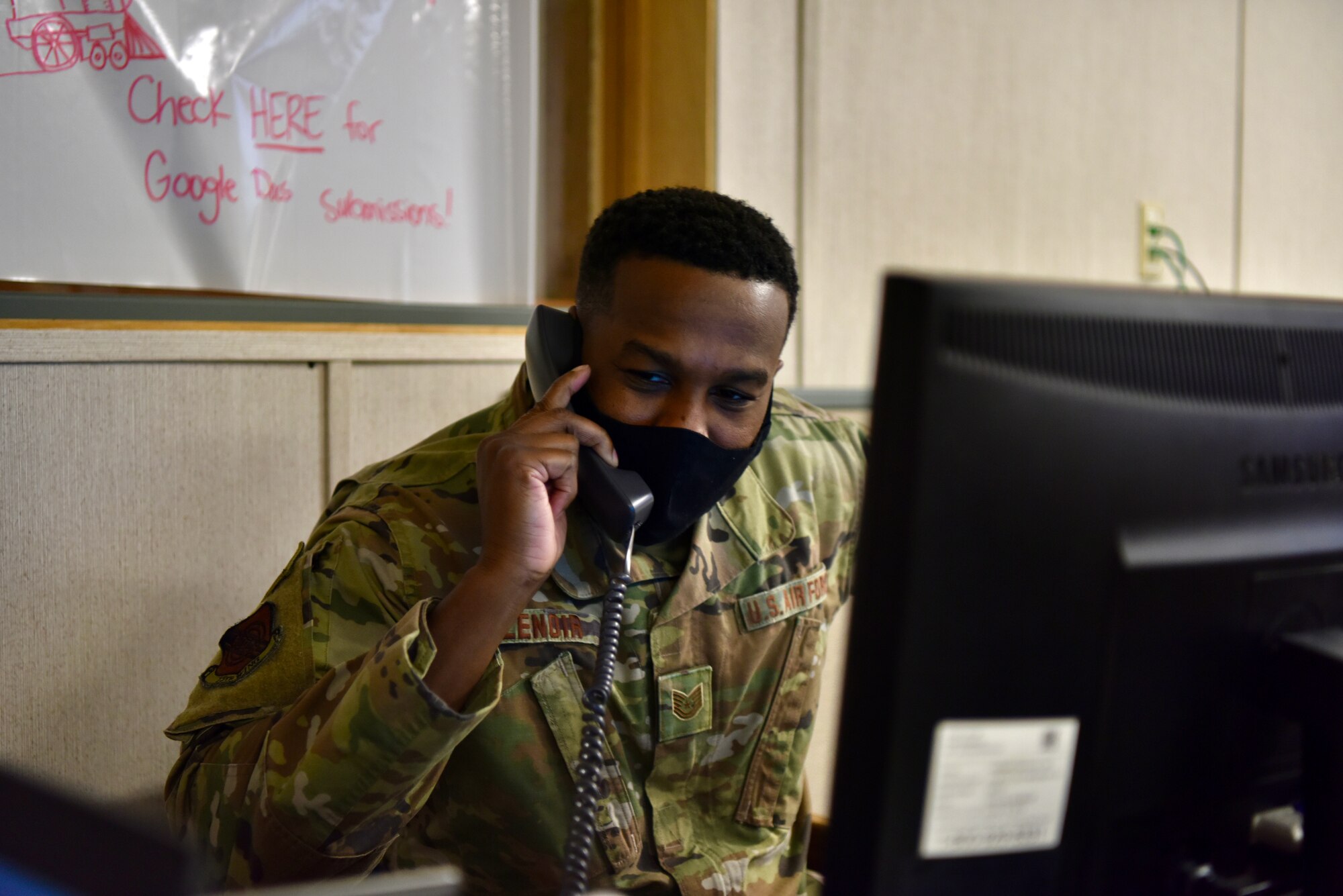 Tech. Sgt. Harry Lenoir, Joint Base Pearl Harbor-Hickam Emergency Operations Center phone operator technician, assists with hotel questions over the phone at Joint Base Pearl Harbor-Hickam, Hawaii, Dec. 14, 2021. The EOC is operated by a joint-military team, working 24/7, for the duration of the water issues. (U.S. Air Force photo by 1st Lt. Benjamin Aronson)
