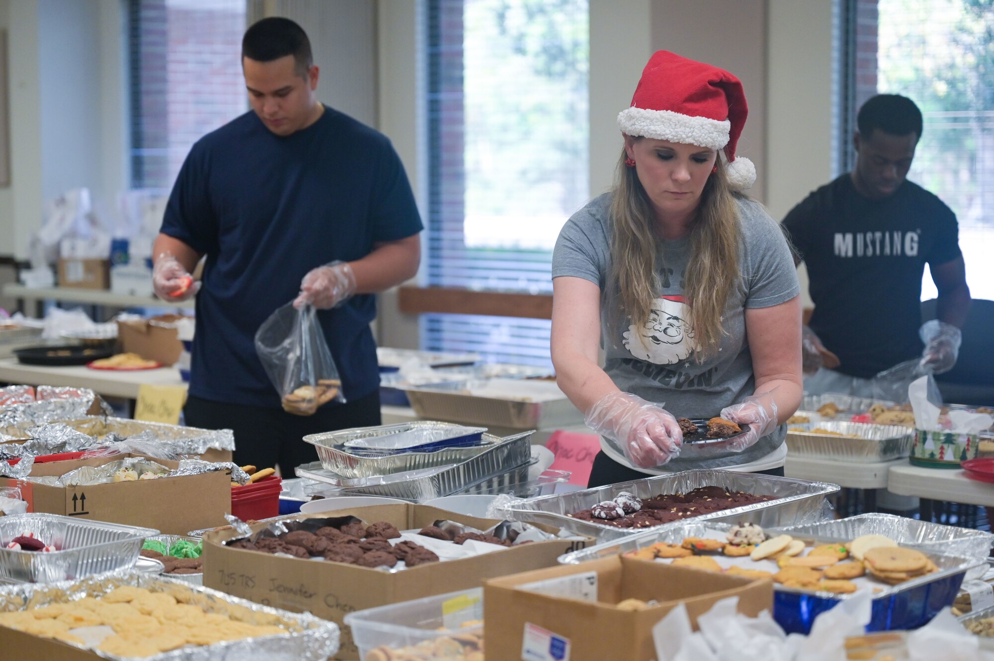 Julie Daniels, a member of the Hurlburt Spouses’ Club, prepares a plate of cookies during the Commando Cookie Drive in the Hurlburt Field Chapel