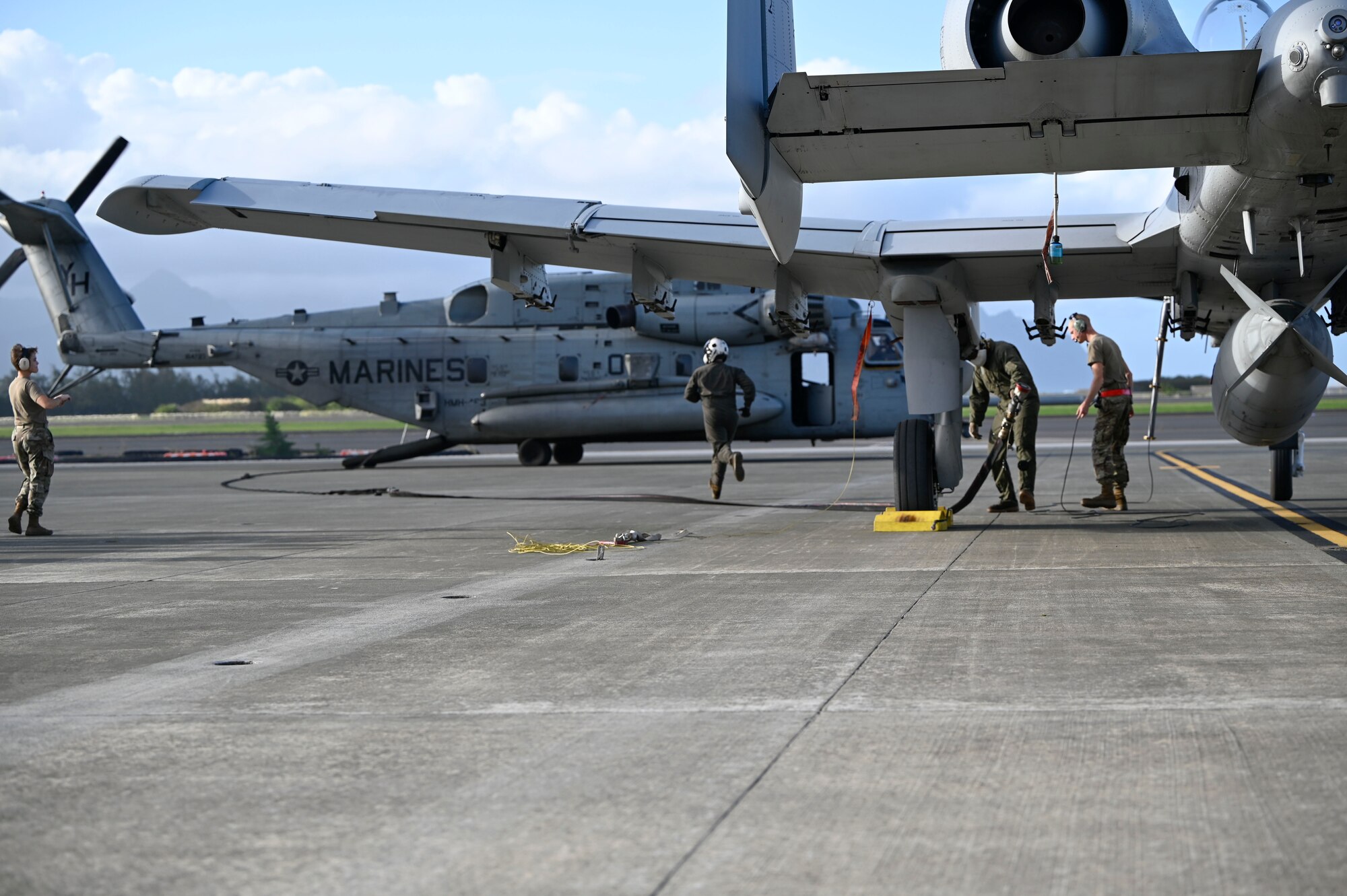 A Marine Corps Forward Area Refueling Point team practices aviation-delivered ground refueling (ADGR) from a CH-53 to A-10s during Exercise KANI WILDCAT. ADGR is frequently used for aircraft when unable to refuel in flight and/or to keep the aircraft closer to the fight.