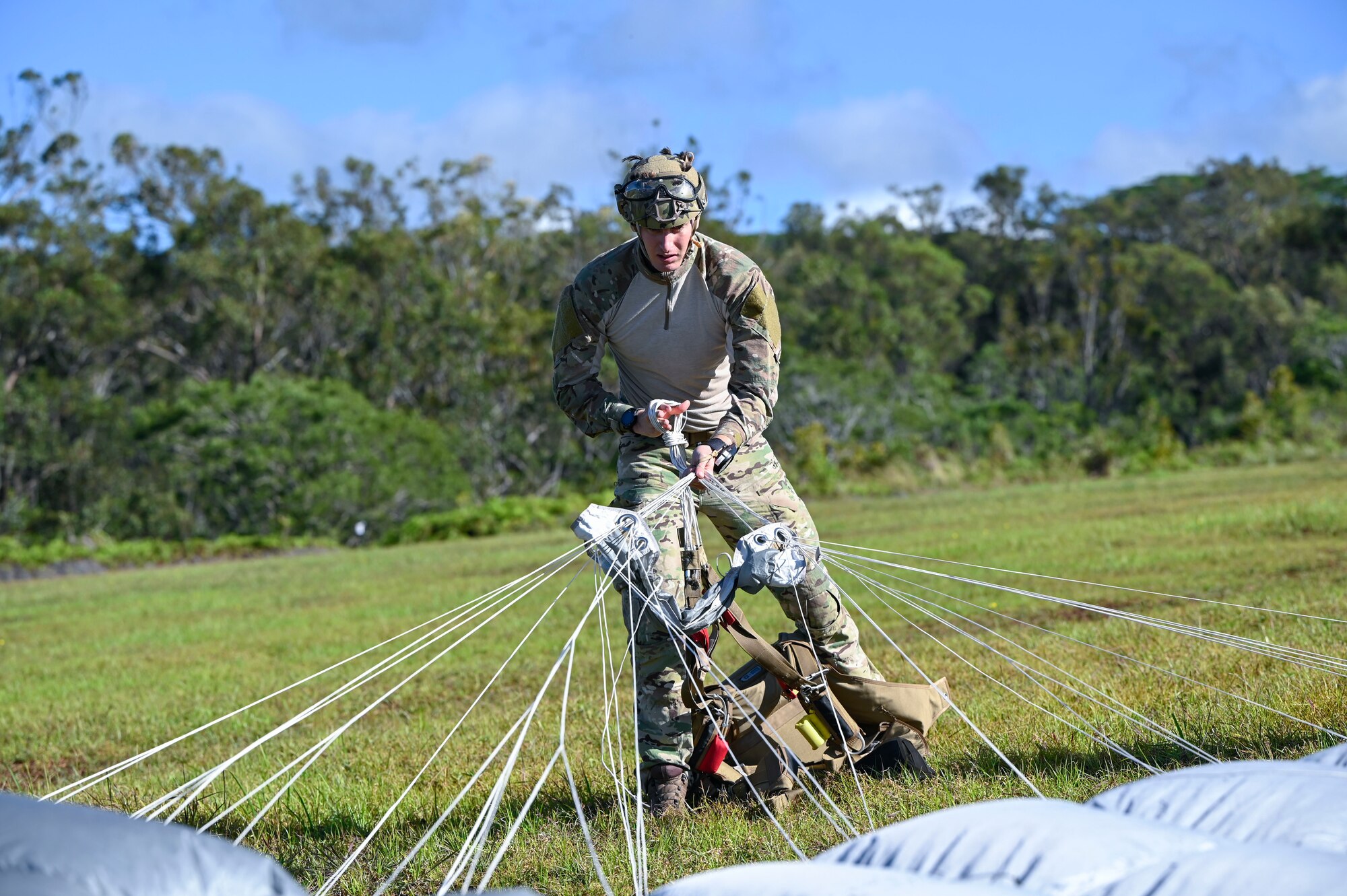 A Special Warfare Airman recovers his parachute after a freefall jump from an AATC C-130 as part of training during Exercise KANI WILDCAT.