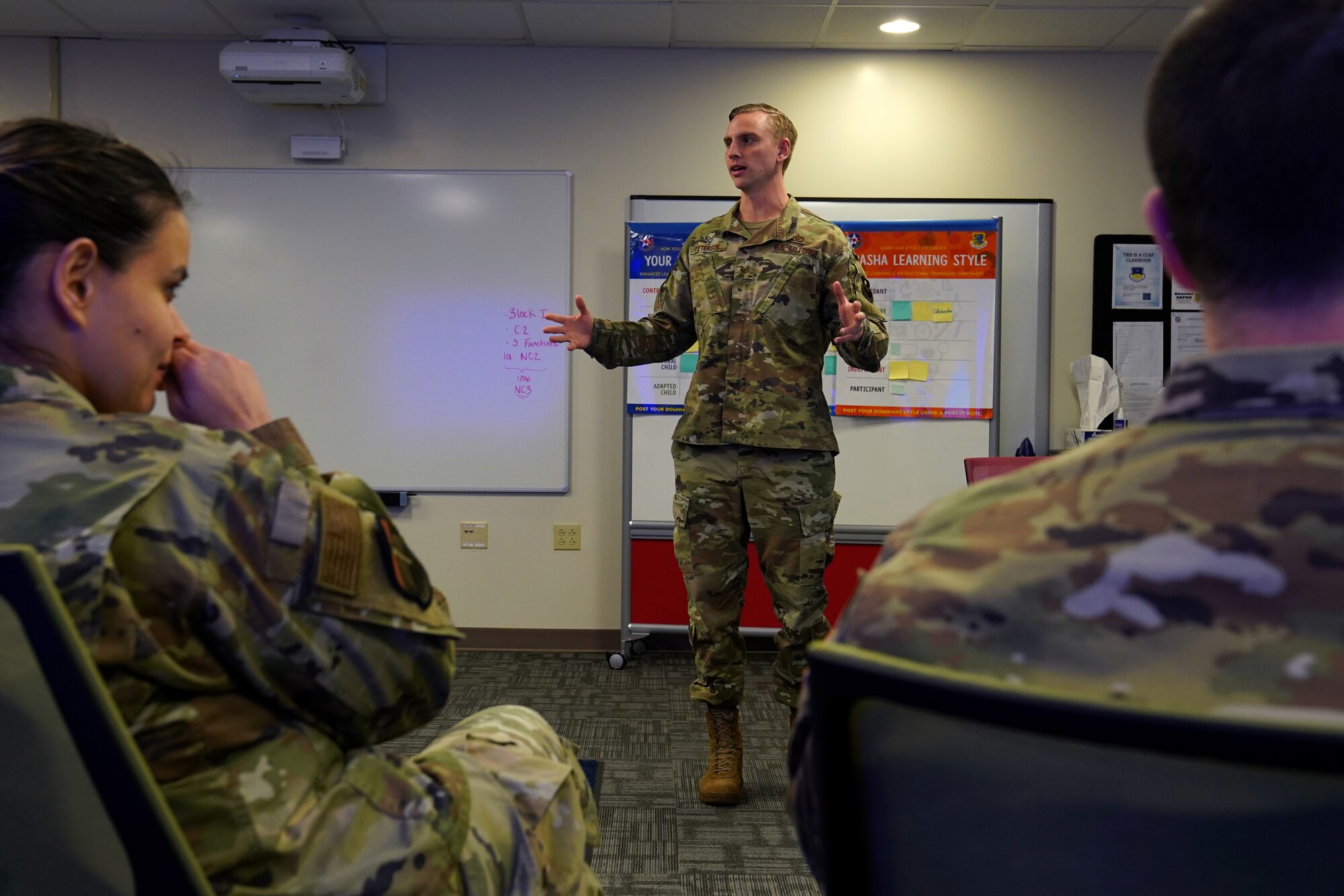U.S. Air Force Tech. Sgt. Dylan Peterson, 366th Training Squadron, civil engineering instructor, Naval Construction Battalion Center, Gulfport, Mississippi, practices instruction with Tech. Sgt. Luz Marcee, 334th Training Squadron command and control operations instructor, and U.S. Space Force Tech. Sgt. Caleb Sutton, 62nd Cyber Space Squadron incident response instructor, Buckley Space Force Base, Colorado, during the Enhanced Learning & Instructional Techniques Enrichment course inside Allee Hall at Keesler Air Force Base, Mississippi, Nov. 19, 2021. The ELITE course introduces active and hands-on learning techniques to Air Force and Space Force instructors to enhance student engagement. (U.S. Air Force photo by Senior Airman Seth Haddix)
