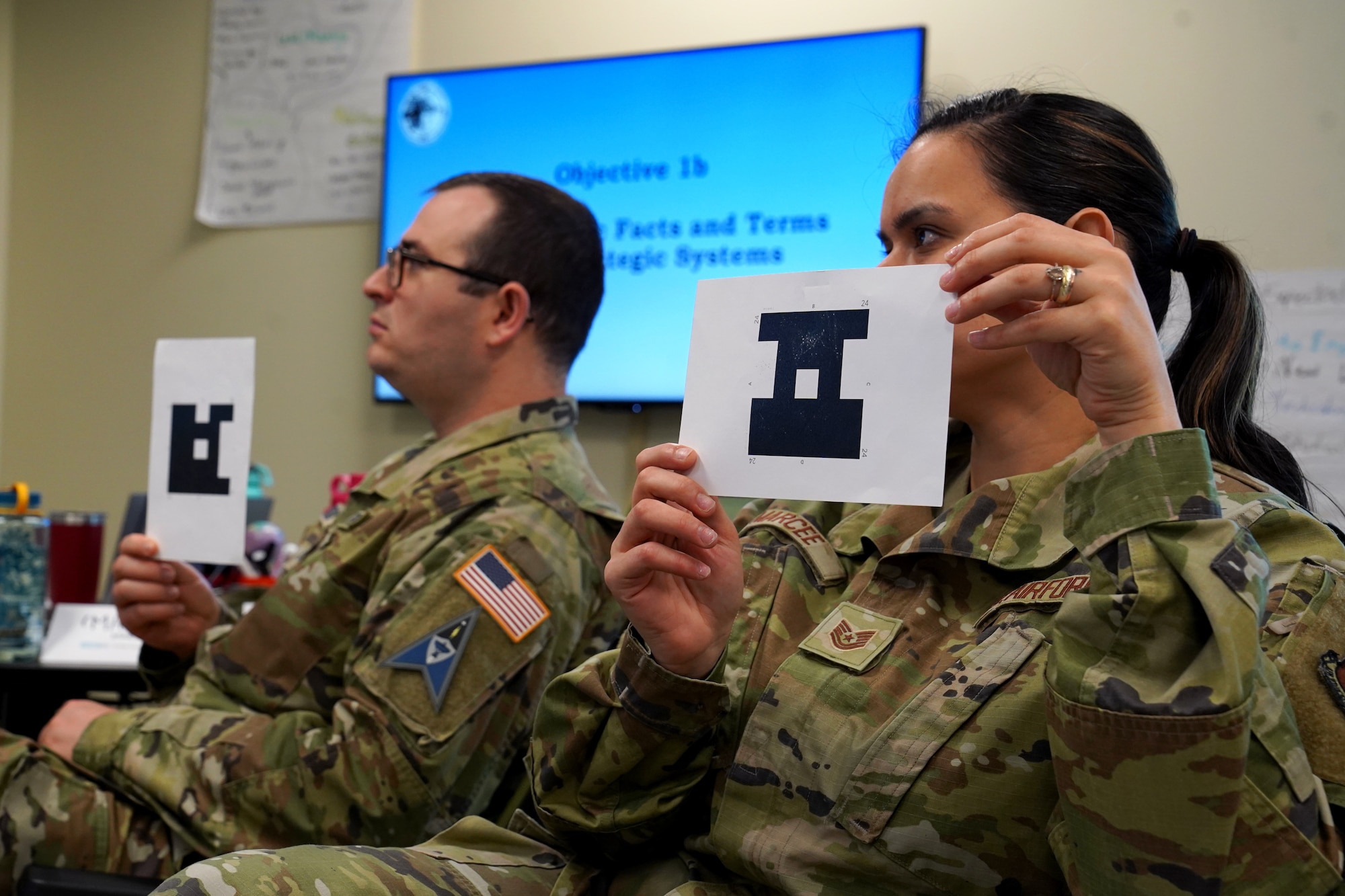 U.S. Air Force Tech. Sgt. Luz Marcee, 334th Training Squadron command and control operations instructor, and U.S. Space Force Tech. Sgt. Caleb Sutton, 62nd Cyber Space Squadron incident response instructor, Buckley Space Force Base, Colorado, participate in a class exercise during the Enhanced Learning & Instructional Techniques Enrichment course inside Allee Hall at Keesler Air Force Base, Mississippi, Nov. 19, 2021. The ELITE course introduces active and hands-on learning techniques to Air Force and Space Force instructors to enhance student engagement. (U.S. Air Force photo by Senior Airman Seth Haddix)
