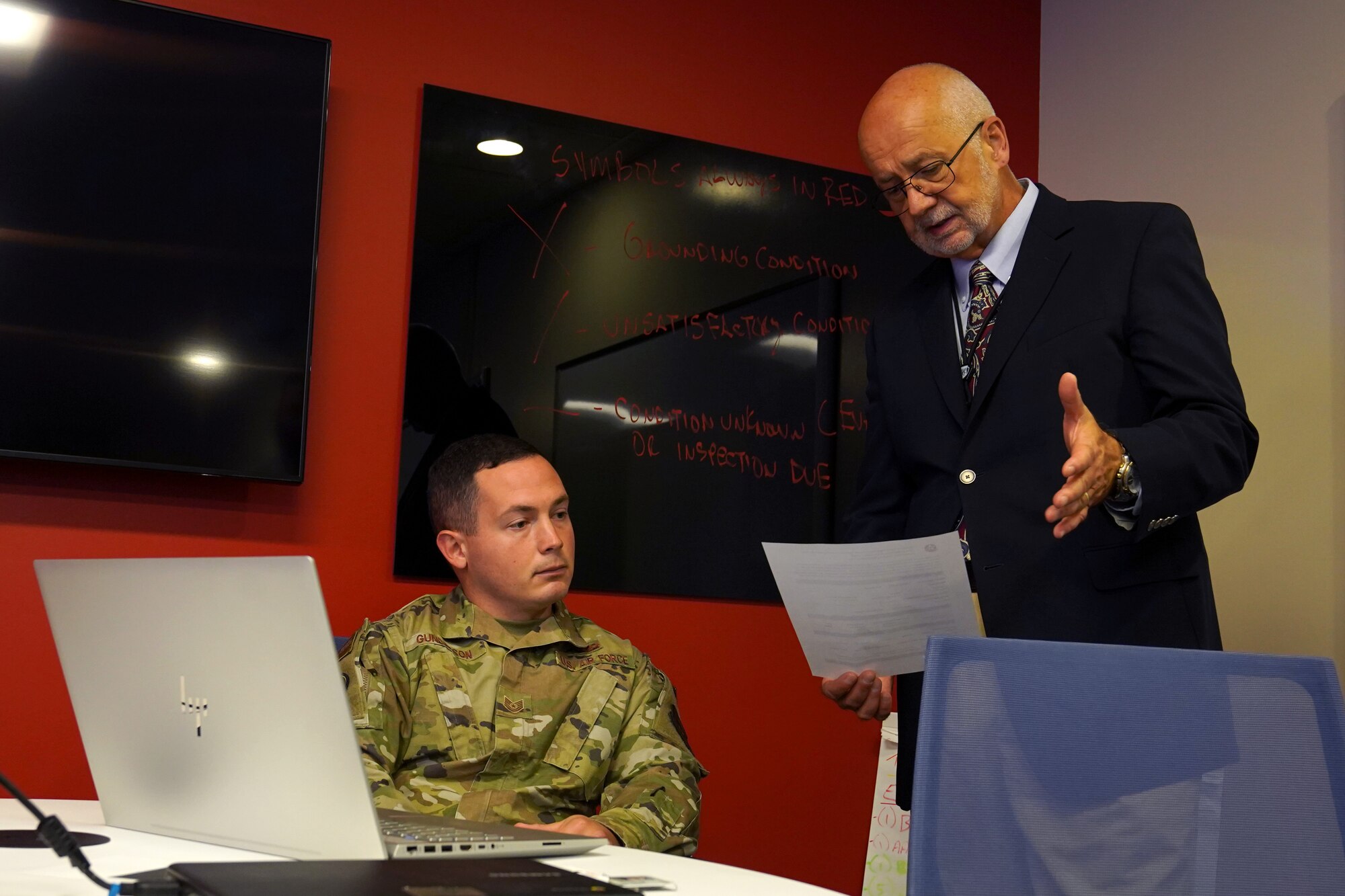 Tim Boileau, 81st Training Support Squadron Enhanced Learning & Instruction Techniques Enrichment course director, teaches learning techniques to U.S. Air Force Tech. Sgt. Ethan Gunderson, 359th Detachment 1 low observance Naval Air Station Pensacola, Florida, inside Allee Hall at Keesler Air Force Base, Dec. 15, 2021. The ELITE course introduces to active and hands-on learning techniques to Air Force and Space Force instructors to enhance student engagement. (U.S. Air Force photo by Senior Airman Seth Haddix)