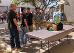 The Kapoi family takes a close-up look at the memorial bonsai tree by Jason Hence. From left to right, Ason Abe - Code 139, Fallyn Kapoi - Code 139, Vernon Kapoi – Shop 38, Vince Kapoi, Sr. – Code 970, Jason Hence, NAVSEA Nondestructive Testing and Welding Programs Manager. (U.S. Navy photo by Dave Amodo released)
