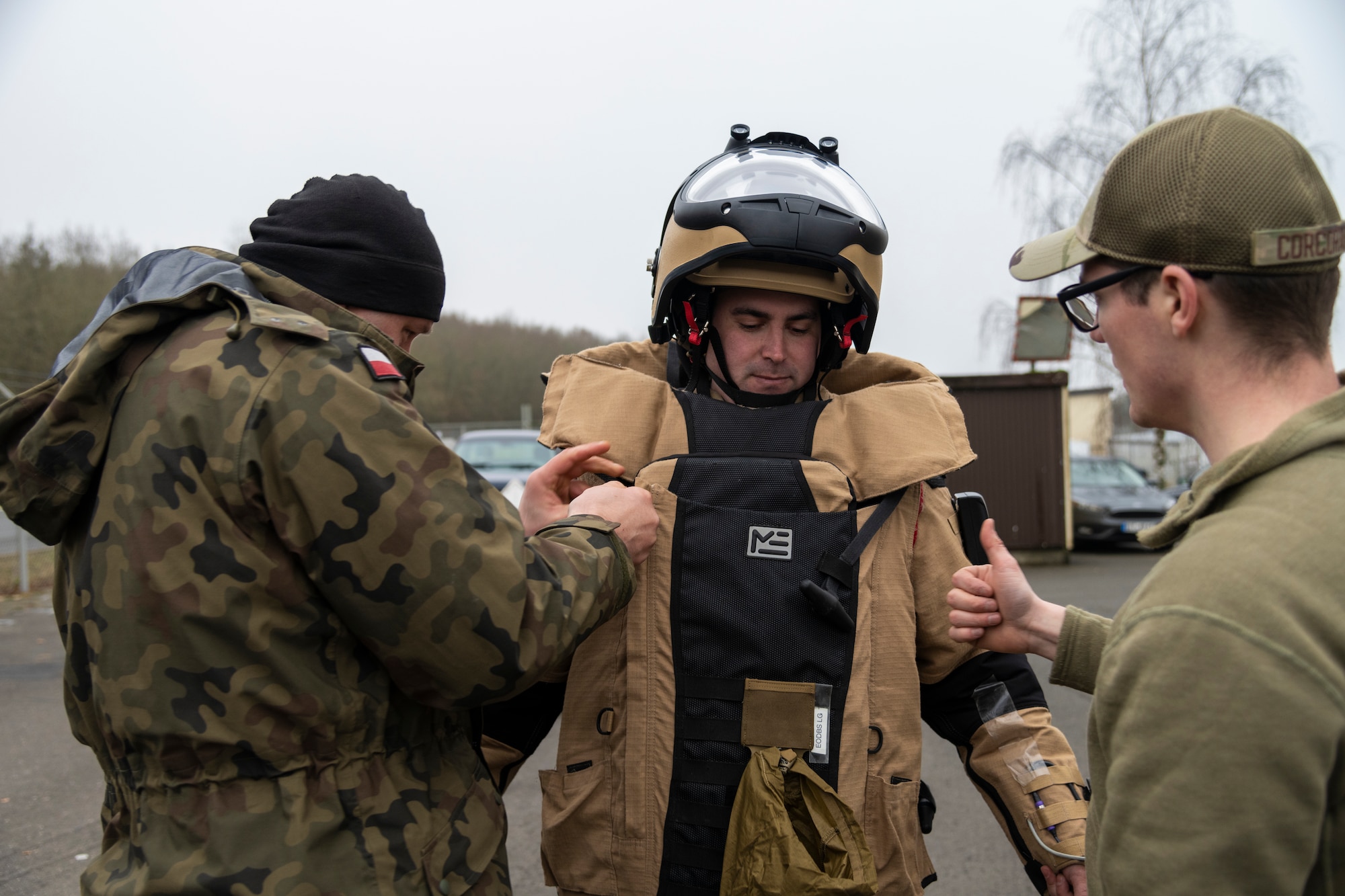 A U.S. Air Force Explosive Ordnance Disposal technician, assigned to the 52nd Fighter Wing Civil Engineer Squadron,  discuss tactics and benefits of the blast suit with a Polish Improvised Explosive Device unit member during the ongoing familiarization and interoperability training at Spangdahlem Air Base, Dec. 9, 2021. These NATO partners routinely train together to strengthen the relationship between the Polish IED unit and 52nd FW EOD team and continue to improve each other’s tactics and procedures. (U.S. Air Force photo by Senior Airman Ali Stewart)