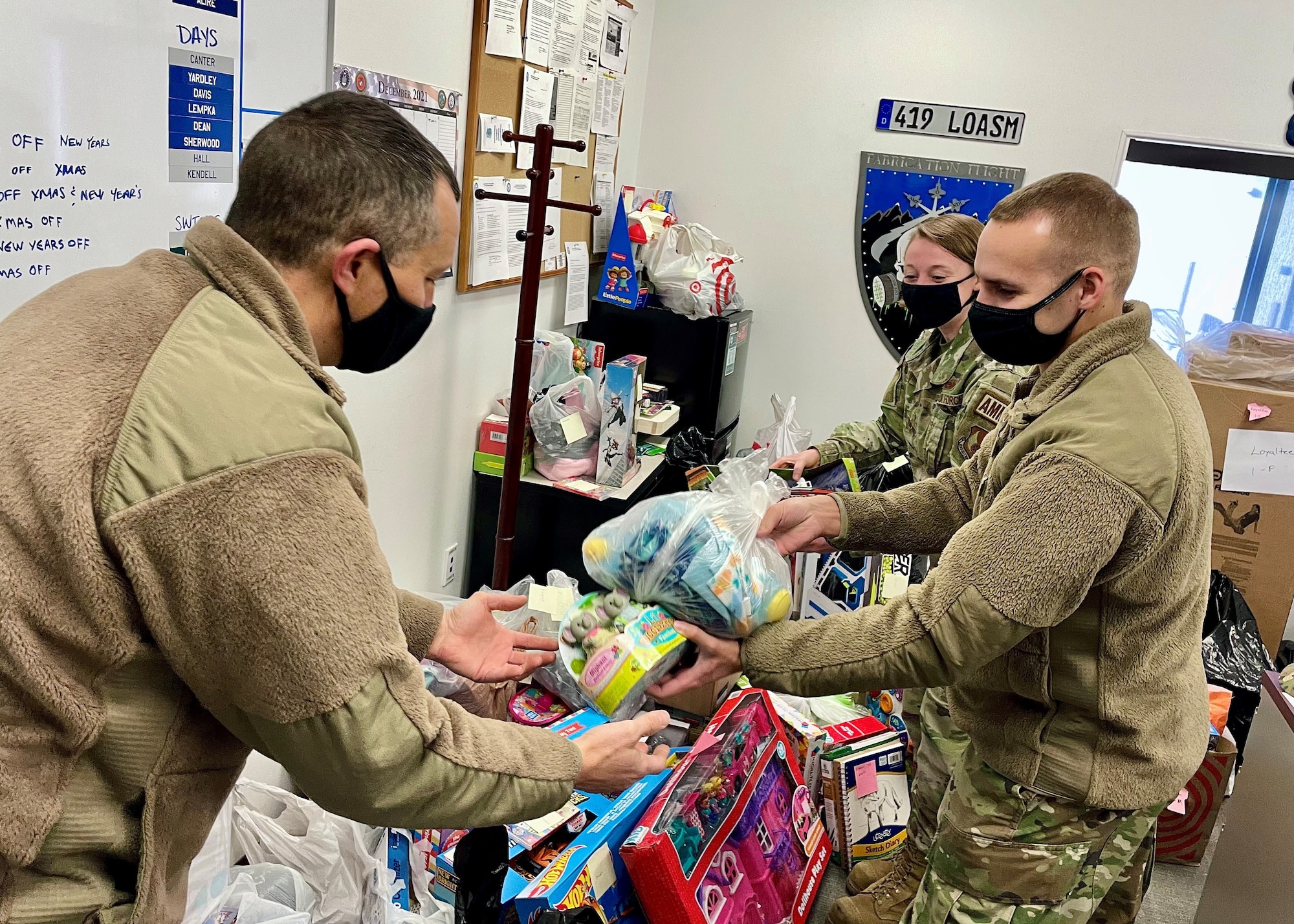 Master Sgt. Andrew Gale (left), reservist in the 419th Maintenance Squadron, helps organize toys alongside Tech. Sgt. Rachel Shelly and Tech. Sgt. Robert Spear as part of the “Santa Brigade” effort to deliver Christmas gifts to Utah children in foster care