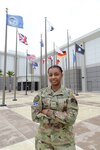 Specialist 4 Quineaja Davis stands for a photo in front of the Combined Force Space Component Command headquarters building Dec. 13, 2021, at Vandenberg Space Force Base, California.