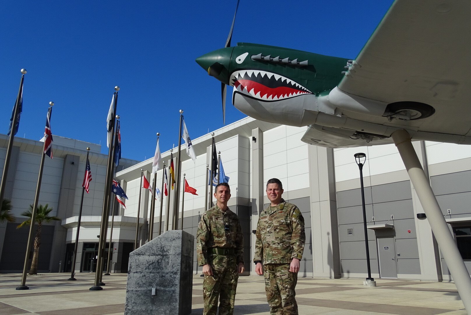 Royal Air Force Air Vice-Marshal Paul Godfrey (left), UK Space Command commander, stands in front of the Combined Force Space Component Command (CFSCC) headquarters building with Brig. Gen. Michael Conley (right), CFSCC deputy commander, Dec. 10, 2021, at Vandenberg Space Force Base, Calif. During his visit, Godfrey met with CFSCC leadership and UK personnel based at Vandenberg, to discuss the integration of UK and U.S. personnel, operations, and space capabilities. Established on Apr. 1, 2021, UK Space Command is a joint command staffed from the Royal Navy, British Army, Royal Air Force, civil service, and key members of the commercial sector. The command brings together three functions under a single two-star military commander: space operations, space workforce training and growth, and space capability. (U.S. Space Force photo by Capt. Jefferson Mitchell)