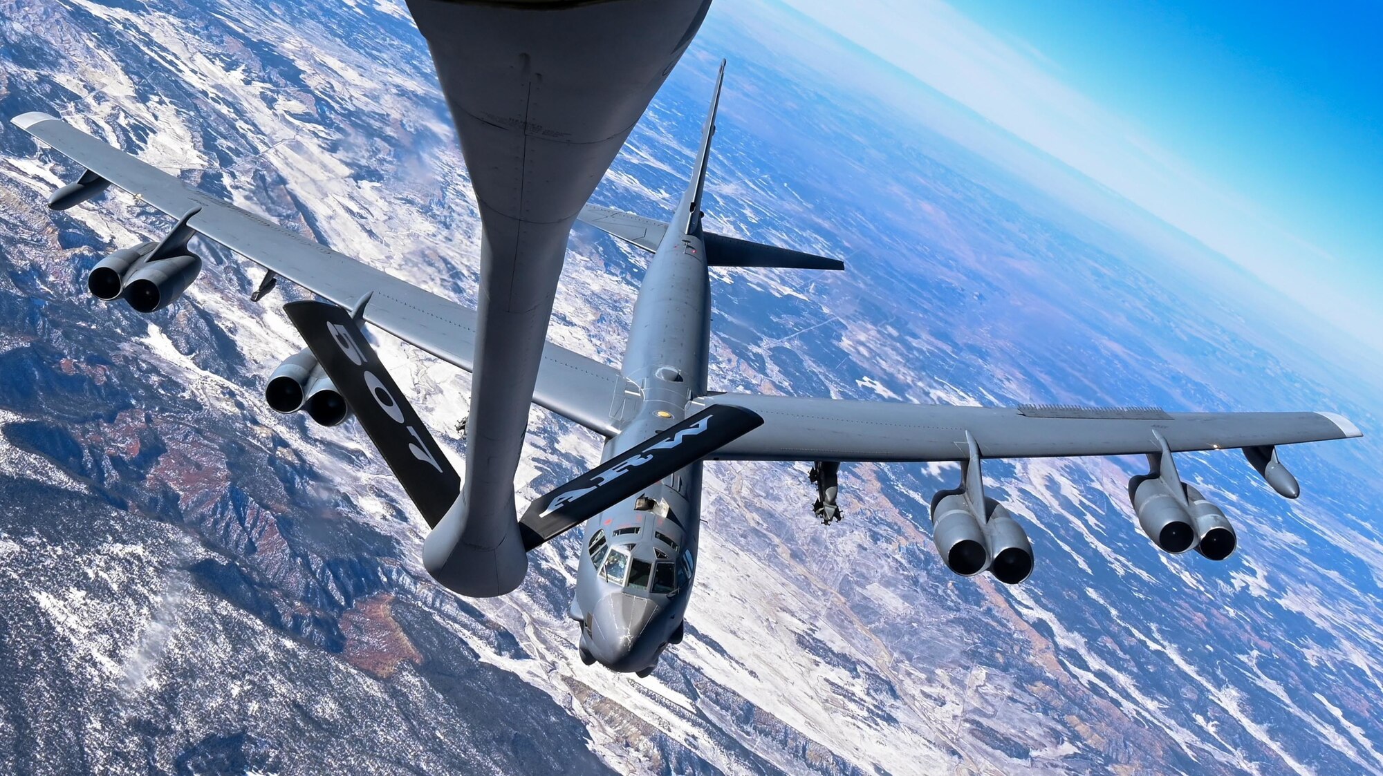 A B-52 Stratofortress assigned to the 96th Bomb Squadron Barksdale Air Force Base, Louisiana, prepares to refuel with a KC-135 Stratotanker assigned to the 465th Air Refueling Squadron, Tinker AFB, Oklahoma, above the Rocky Mountains, Dec. 13, 2021. Aerial refueling allows aircraft to travel vast distances without landing to bring airpower anytime, anywhere around the world. (U.S. Air Force photo by 2nd Lt. Mary Begy