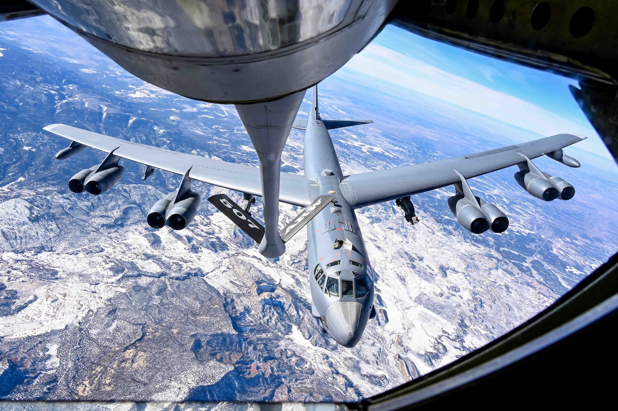 A B-52 Stratofortress assigned to the 96th Bomb Squadron Barksdale Air Force Base, Louisiana, prepares to refuel with a KC-135 Stratotanker assigned to the 465th Air Refueling Squadron, Tinker AFB, Oklahoma, above the Rocky Mountains, Dec. 13, 2021. Aerial refueling allows aircraft to travel vast distances without landing to bring airpower anytime, anywhere around the world. (U.S. Air Force photo by 2nd Lt. Mary Begy)