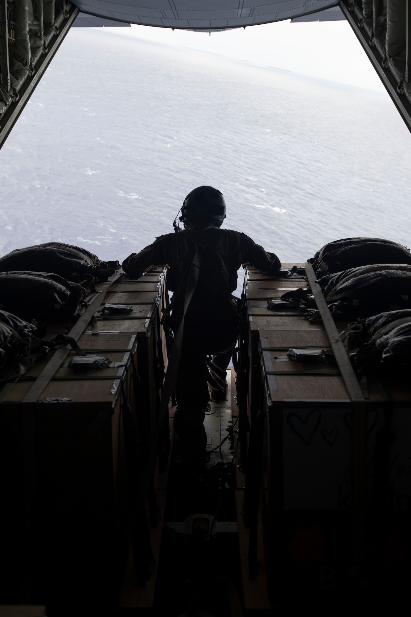 Airman 1st Class Milo Carter, 36th Airlift Squadron loadmaster, watches for the drop zone near Asor, Dec. 5, 2021, for the 70th Anniversary of Operation Christmas Drop. OCD is the Department of Defense’s longest-running humanitarian aid and disaster relief training mission and provides relief to more than 55 islands throughout the Pacific. Operations such as OCD provide the U.S. and its partners the opportunity to enhance joint operational capabilities and maintain preparedness for real-world emergencies. (U.S. Air Force photo by Tech. Sgt. Joshua Edwards)