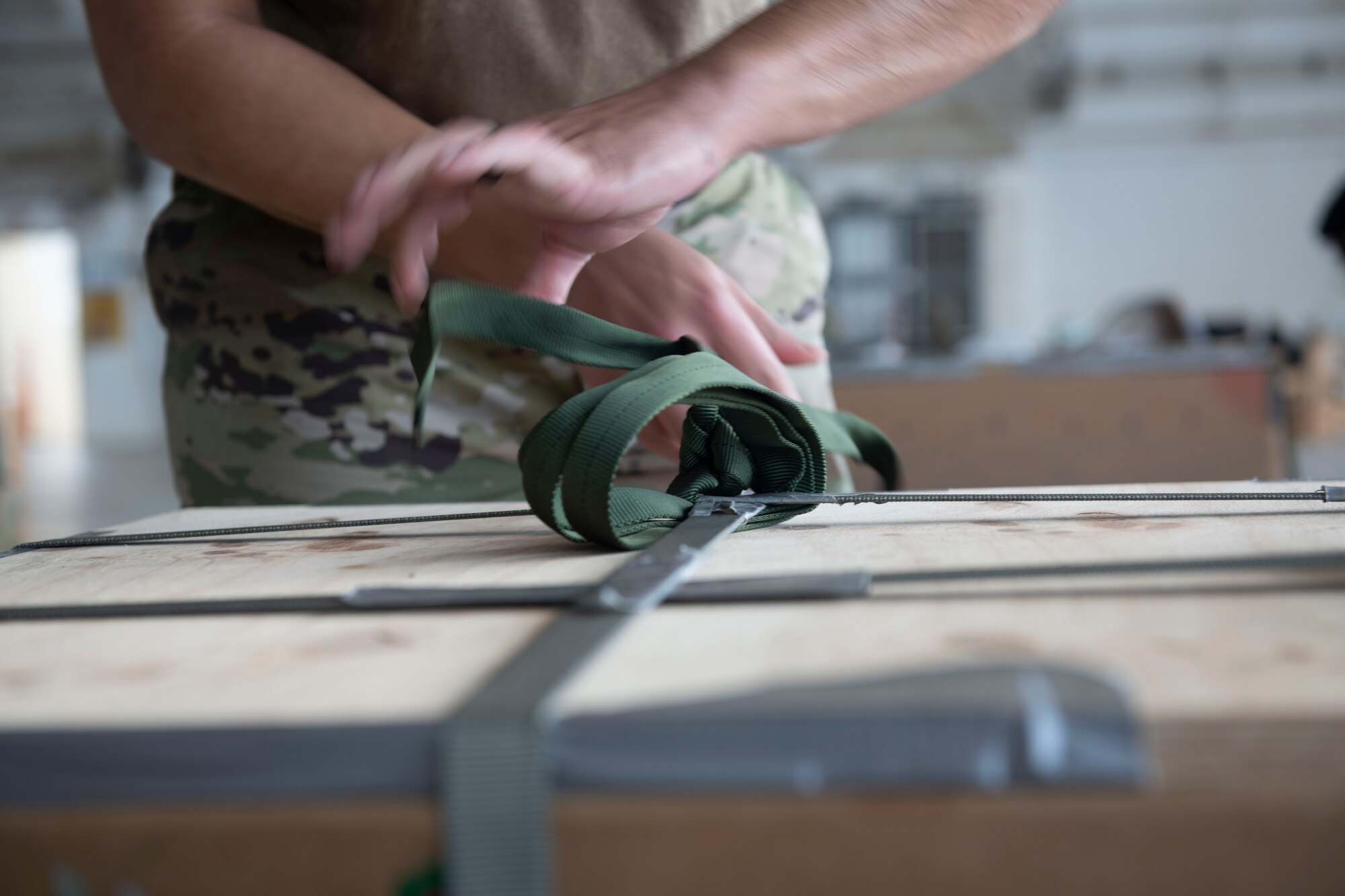 Staff Sgt. Samuel Fletcher, 374th Logistics Readiness Squadron combat mobility flight supervisor, prepares a bundle during the 70th Anniversary of Operation Christmas Drop at Andersen Air Force Base, Guam, Dec. 8, 2021. OCD is the Department of Defense’s longest-running humanitarian aid and disaster relief training mission and provides relief to more than 55 islands throughout the Pacific. Operations such as OCD provide the U.S. and its partners the opportunity to enhance joint operational capabilities and maintain preparedness for real-world emergencies. (U.S. Air Force photo by Tech. Sgt. Joshua Edwards)