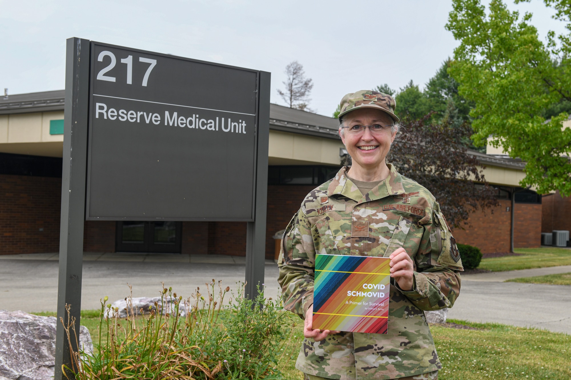 Col. Colleen Kelley, 910th Medical Squadron commander, poses with her recently published book, “COVID SCHMOVID”, Aug. 8, 2021, in front of the 910th Medical Squadron building at Youngstown Air Reserve Station.