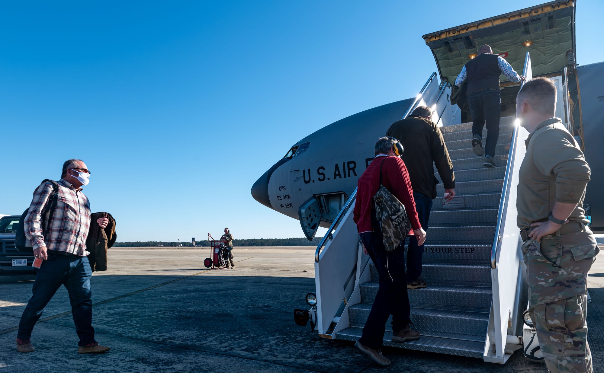 A photo of people boarding a plane.