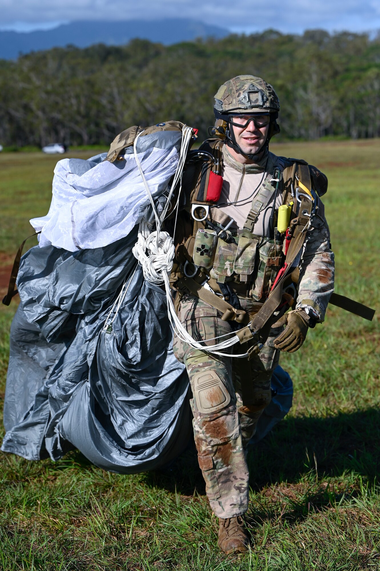 An Air force Combat Rescue Officer recovers his parachute after a freefall jump from an AATC C-130 as part of training during Exercise KANI WILDCAT.