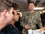 Lt. Matthew Moynihan, Chaplain aboard Arleigh Burke-class guided-missile destroyer USS Higgins (DDG 76) greets Sailors during an MWR event. Higgins is assigned to Commander, Task Force (CTF) 71/Destroyer Squadron (DESRON) 15, the Navy's largest forward-deployed DESRON and the U.S. 7th Fleet's principal surface force.