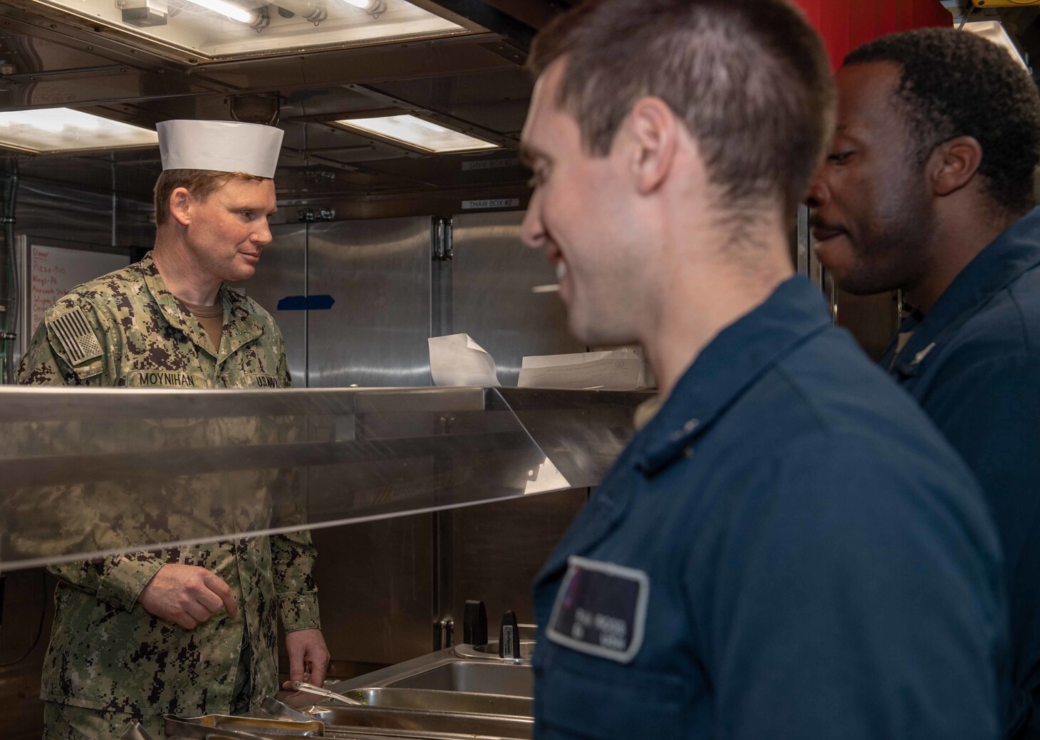 Lt. Matthew Moynihan, Chaplain aboard Arleigh Burke-class guided-missile destroyer USS Higgins (DDG 76) serves Sailors during a meal. Higgins is assigned to Commander, Task Force (CTF) 71/Destroyer Squadron (DESRON) 15, the Navy's largest forward-deployed DESRON and the U.S. 7th Fleet's principal surface force.