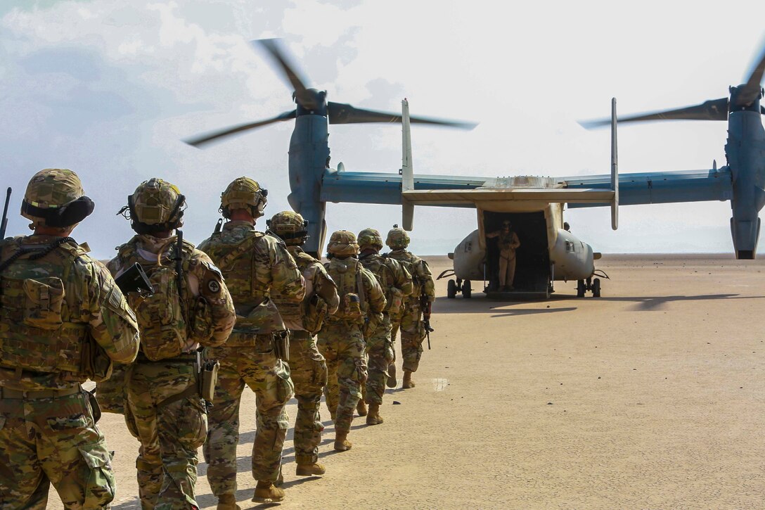U.S. Army Soldiers assigned to the East Africa Response Force (EARF) in support of Combined Joint Task Force - Horn of Africa (CJTF-HOA), load a U.S. Marine Corps MV-22 Osprey assigned to Marine Medium Tiltrotor Squadron (VMM) 161, at Camp Lemonnier, Djibouti, Nov 14, 2021. This was the first training event with the Marines and Soldiers, familiarizing them with the aircraft for future crisis and contingency operations. (U.S. Marine Corps photo by Staff Sgt. Brytani Musick)