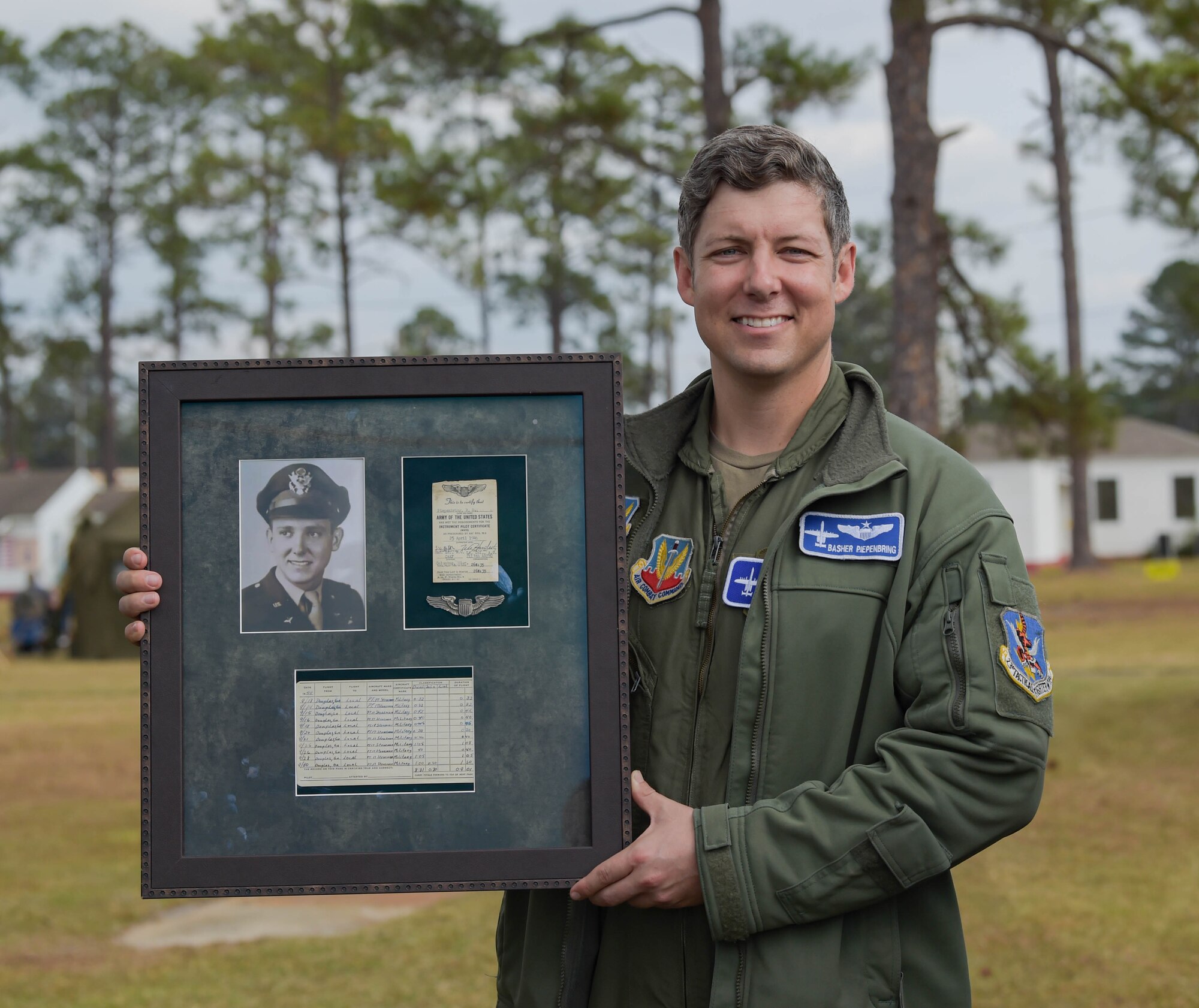 U.S. Air Force Maj. Will Piepenbring, 23rd Fighter Group assistant director of operations and A-10C Thunderbolt II pilot, holds a framed photo of his grandfather at Douglas, Georgia, Dec. 4, 2021. Retired 2nd Lt. Richard Piepenbring served during WWII as a PT-17 Stearman pilot with the 63rd Flight Training Detachment from July through December 1944. Piepenbring's grandfather inspired him to go into aviation. (U.S. Air Force photo by Senior Airman Rebeckah Medeiros)