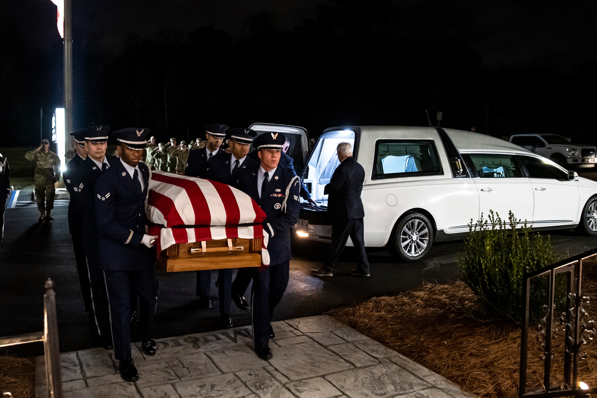 Photo of Airmen carrying a casket