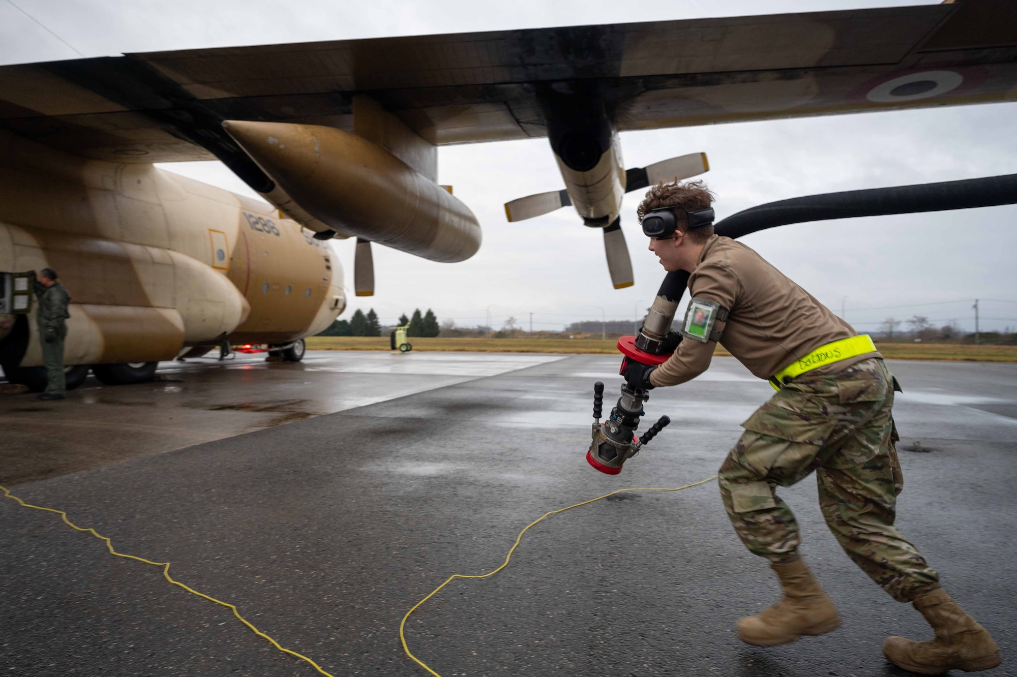 Airman 1st Class Dalton Settlemire, 436th Logistics Readiness Squadron fuels distribution operator, prepares to refuel an Egyptian Air Force C-130 Hercules during a foreign military sales mission at Dover Air Force Base, Delaware, Dec. 11, 2021. The United States and Egypt share a strong partnership based on mutual interest in Middle East peace and stability, economic opportunity and regional security. Due to its strategic location, Dover AFB supports approximately $3.5 billion worth of foreign military sales annually. (U.S. Air Force photo by Senior Airman Faith Schaefer) (This photo has been altered for security purposes by blurring out identification badges.)