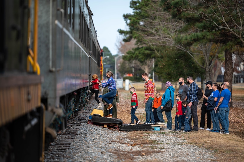 Members of the JBLE community board a train for Operation Sgt. Santa at Joint Base Langley-Eustis, Virginia, Dec. 11, 2021.