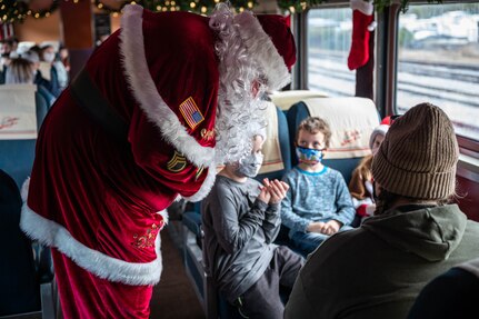Sgt. Santa brings candy to children on the train during Operation Sgt. Santa at Joint Base Langley-Eustis, Virginia, Dec. 11, 2021.