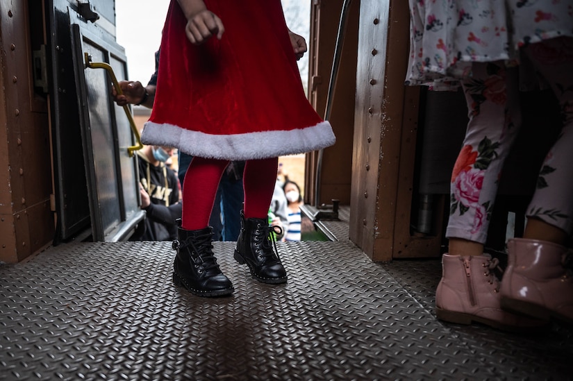 Members of the JBLE community board a train for Operation Sgt. Santa at Joint Base Langley-Eustis, Virginia, Dec. 11, 2021.