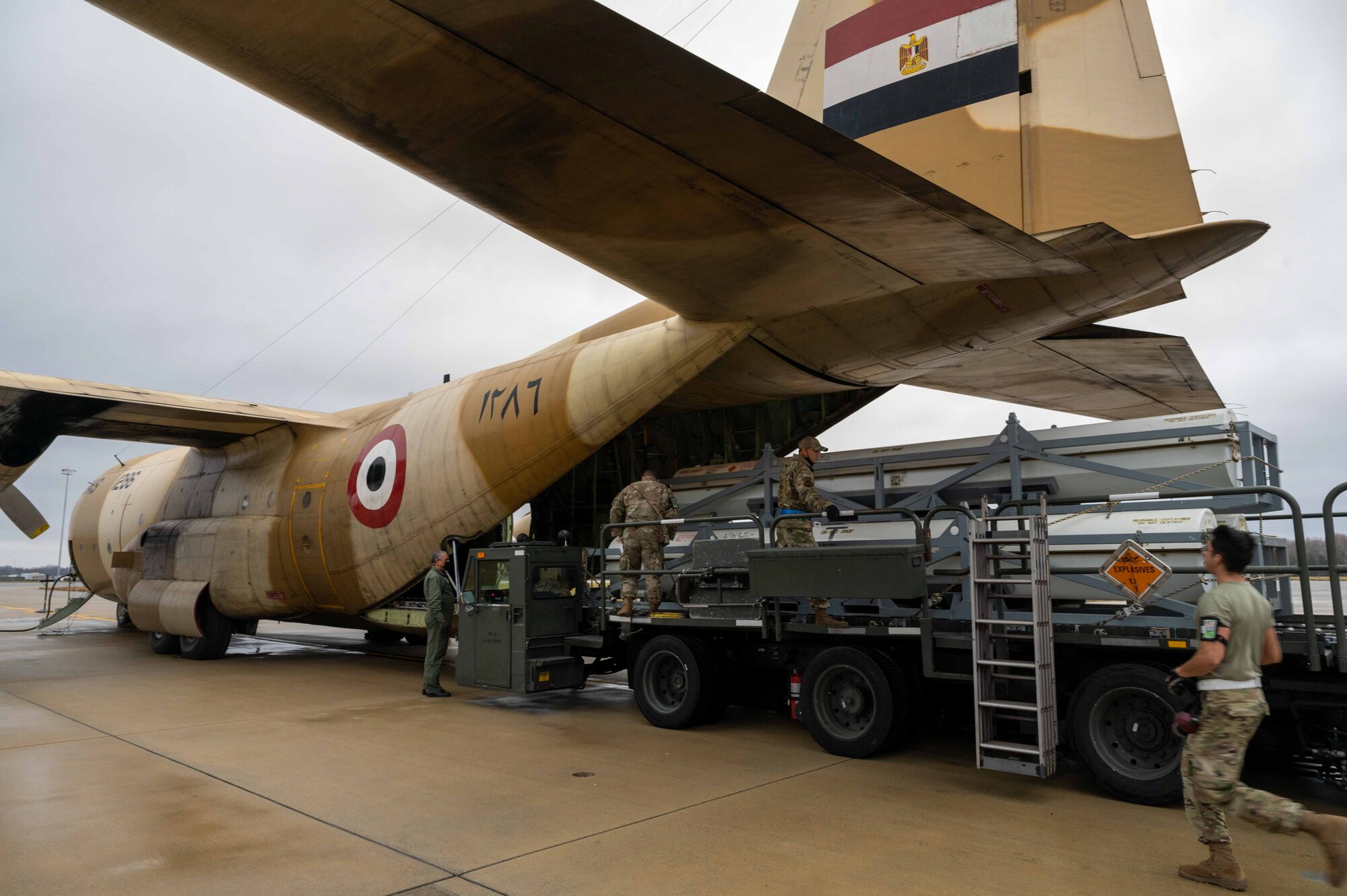 Airmen from the 436th Aerial Port Squadron load cargo onto an Egyptian Air Force C-130 Hercules during a foreign military sales mission at Dover Air Force, Delaware, Dec. 11, 2021. The United States and Egypt share a strong partnership based on mutual interest in Middle East peace and stability, economic opportunity and regional security. Due to its strategic location, Dover AFB supports approximately $3.5 billion worth of foreign military sales annually. (U.S. Air Force photo by Senior Airman Faith Schaefer)