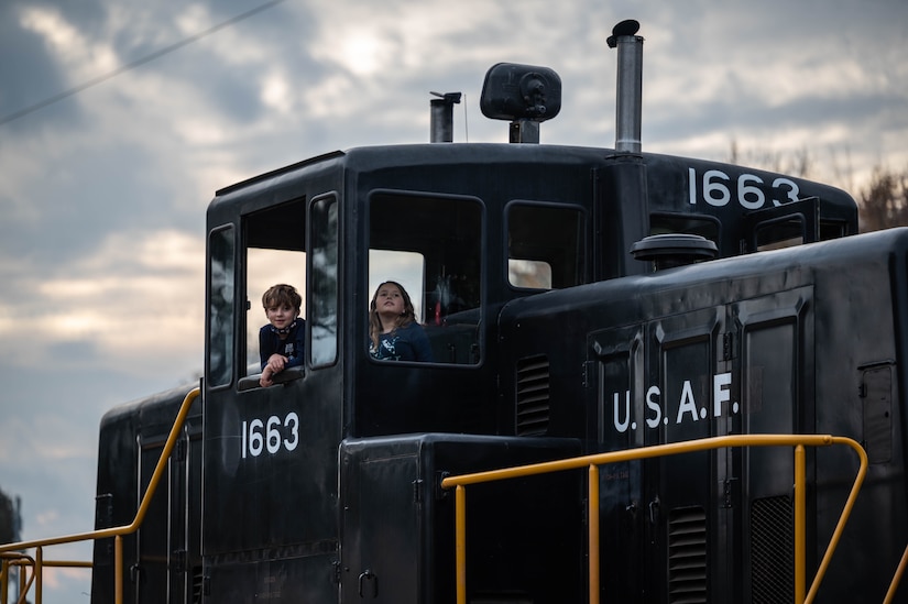 Children of the JBLE community tour the U.S. Air Force 1663, 80-Ton Locomotive during Operation Sgt. Santa at Joint Base Langley-Eustis, Virginia, Dec. 11, 2021.