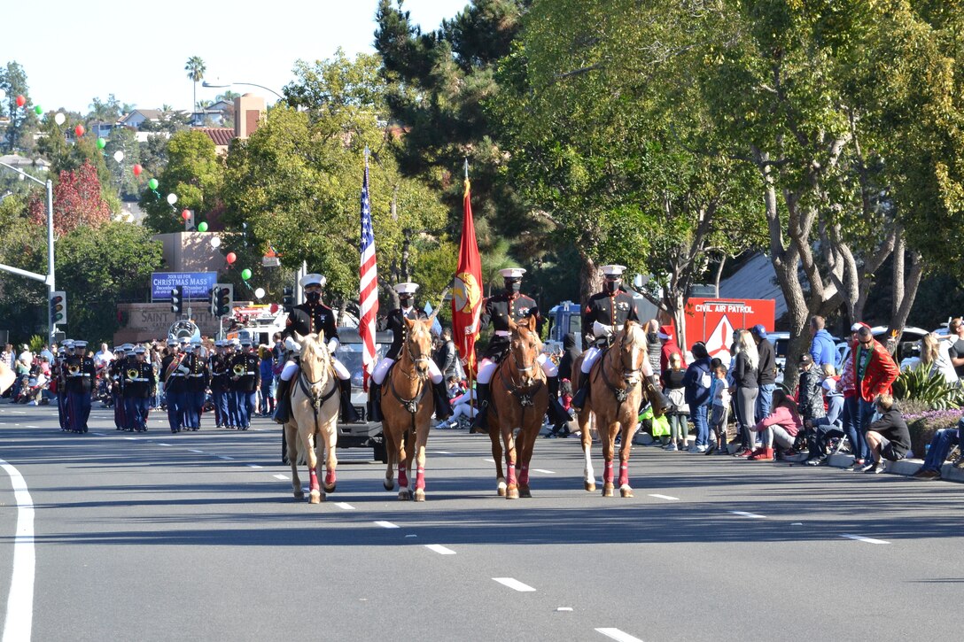 Marines from the Marine Corps Mounted Color Guard lead the Laguna Niguel Holiday Parade in Laguna Niguel, Calif., Dec. 11, 2021.  The Mounted Color Guard attends various events throughout the country and works alongside local recruiting stations to conduct high school visits and community events.  Marines and future Marines from Recruiting Station Orange County visited with the Marines following the parade.  The Mounted Color Guard will participate in the Tournament of Roses Parade on New Year's Day.