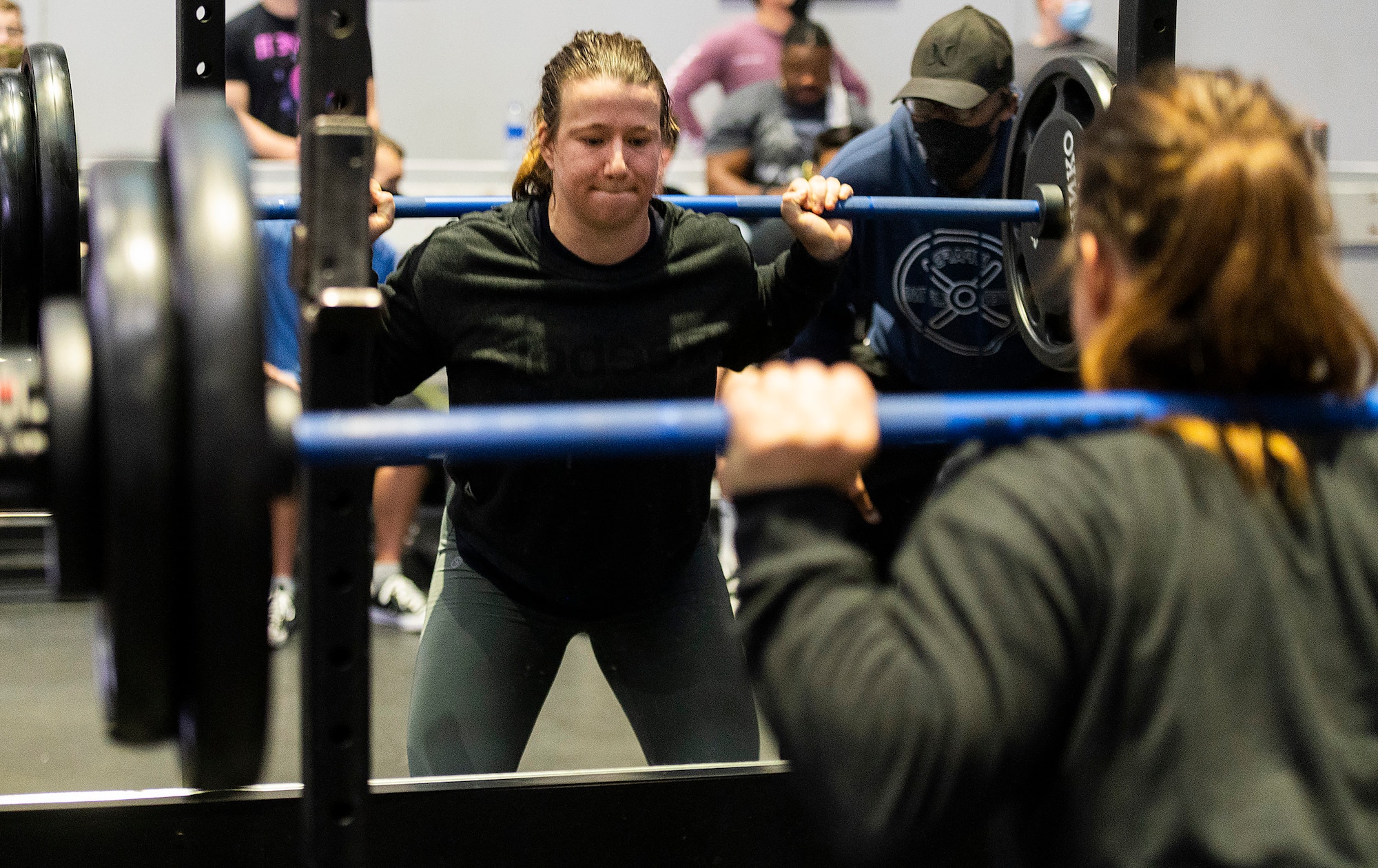 Sierra Dehart, Air Force Institute of Technology, performs a squat in a powerlifting competition in the Wright Field Fitness Center Dec. 11, 2020, at Wright-Patterson Air Force Base. Dehart, who said she had not trained for the event, went on to win the women’s competition. (U.S. Air Force photo by R.J. Oriez)