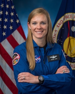 An astronaut poses for a photo.