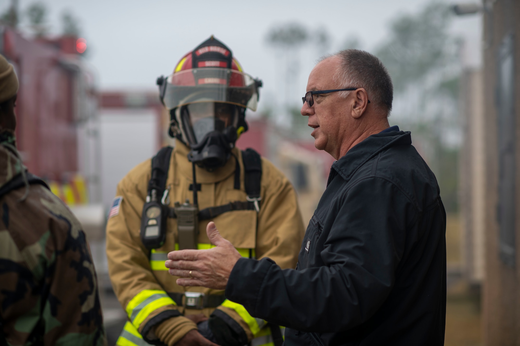An instructor briefs a group of firemen