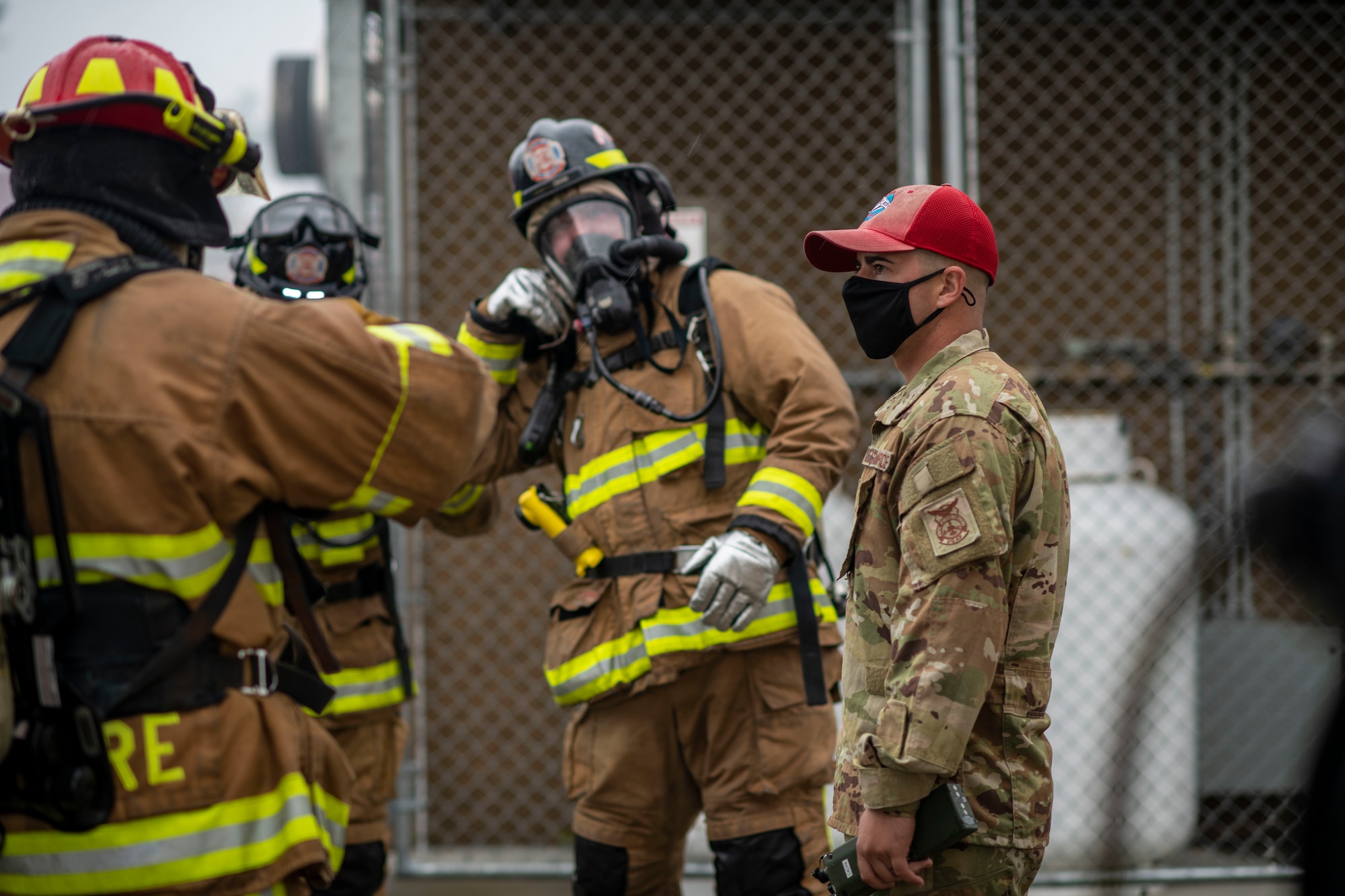 An instructor briefs a group of firemen