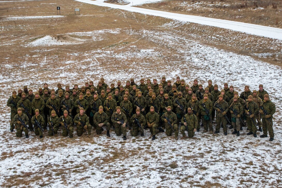 U.S. Marines with 2nd Marine Logistics Group pose for a photo on Fort McCoy, Wisconsin, Dec. 9, 2021. Marines and Sailors with Combat Logistics Battalion 6 and 2nd Transportation Battalion trained in Fort McCoy, Wisconsin, in order to increase lethality and readiness in cold weather environments. (U.S. Marine Corps photo by Cpl. Christian M. Garcia)