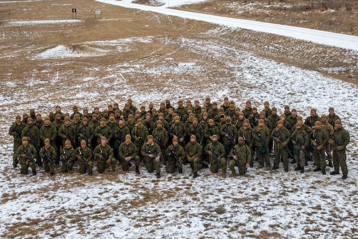 U.S. Marines with 2nd Marine Logistics Group pose for a photo on Fort McCoy, Wisconsin, Dec. 9, 2021. Marines and Sailors with Combat Logistics Battalion 6 and 2nd Transportation Battalion trained in Fort McCoy, Wisconsin, in order to increase lethality and readiness in cold weather environments. (U.S. Marine Corps photo by Cpl. Christian M. Garcia)