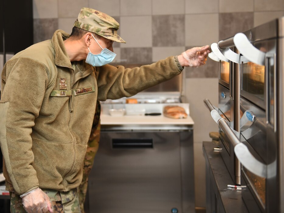 9th Force Support Squadron Airman checks the oven at the new Dragon’s Lair Dec. 15, 2021 at Beale Air Force Base, California.