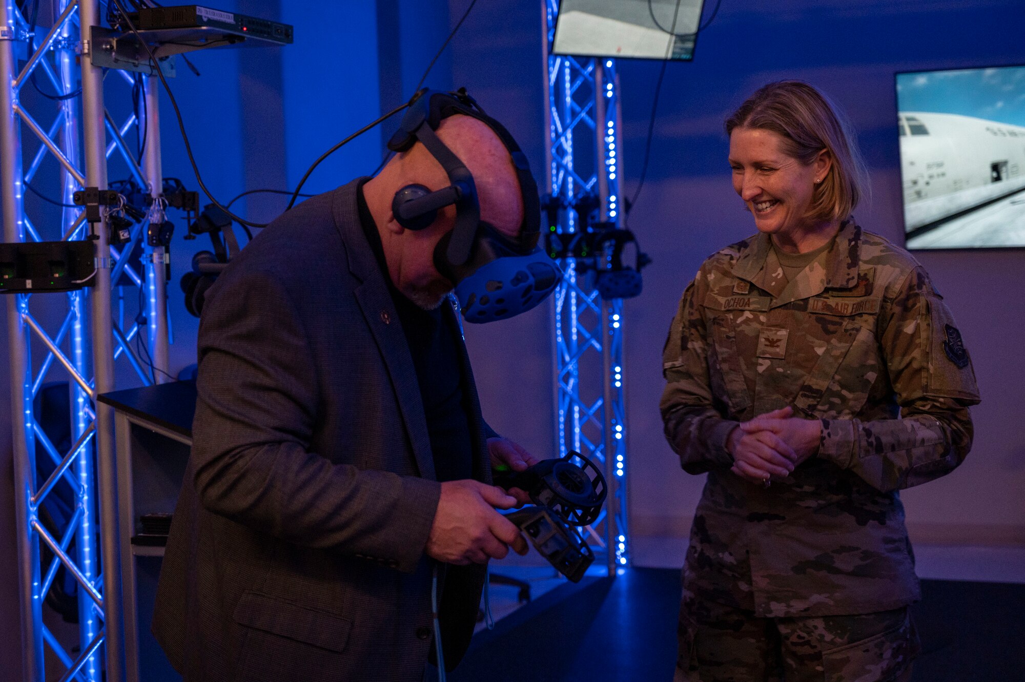 Col. Ochoa observes as an honorary commander experiences the virtual reality maintenance hangar.