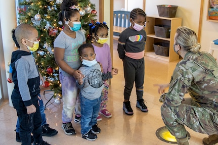 Col. Paige M. Jennings, U.S. Army Financial Management Command commander, talks with students at a local childcare center in Indianapolis Dec. 13, 2021. Jennings was joined by Barry W. Hoffman, USAFMCOM deputy to the commander; Command Sgt. Maj. Kenneth F. Law, USAFMCOM senior enlisted advisor; and Valerie Dillon, USAFMCOM secretary to the general staff, as they handed out special holiday presents to approximately 85 students. (U.S. Army photo by Mark R. W. Orders-Woempner)