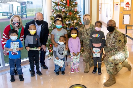 From left to right: Valerie Dillon, U.S. Army Financial Management Command secretary to the gernal staff; Barry W. Hoffman, USAFMCOM deputy to the commander; Col. Paige M. Jennings, USAFMCOM commander; and Command Sgt. Maj. Kenneth F. Law, USAFMCOM senior enlisted advisor, pose for a photo with students at a local childcare center in Indianapolis Dec. 13, 2021. Together, the USAFMCOM leadership team handed out special holiday presents to approximately 85 students. (U.S. Army photo by Mark R. W. Orders-Woempner)