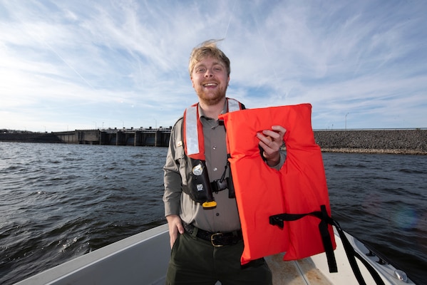 Park Ranger John Poston at J. Percy Priest Lake in Nashville, Tennessee, encourages boaters to always wear a life jacket, which will greatly increase the chances of survival in cold water when visiting a Corps lake. Poston is holding a life jacket Dec. 15, 2021 on a patrol boat near J. Percy Priest Dam. (USACE Photo by Lee Roberts)