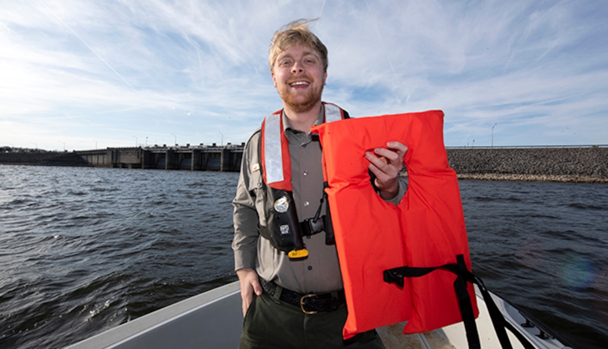 Park Ranger John Poston at J. Percy Priest Lake in Nashville, Tennessee, encourages boaters to always wear a life jacket, which will greatly increase the chances of survival in cold water when visiting a Corps lake. Poston is holding a life jacket Dec. 15, 2021 on a patrol boat near J. Percy Priest Dam. (USACE Photo by Lee Roberts)
