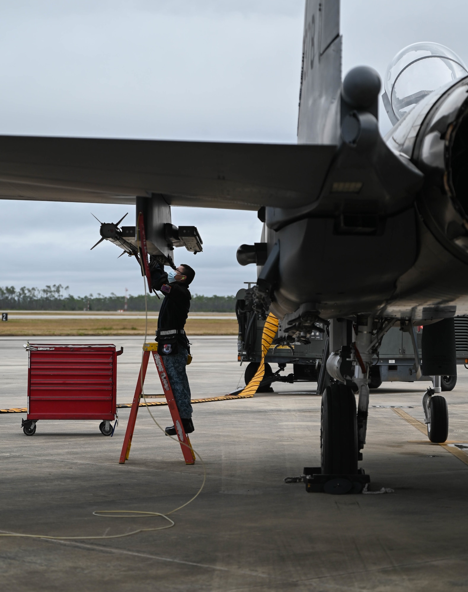 An Airman does an inspection on an aircraft